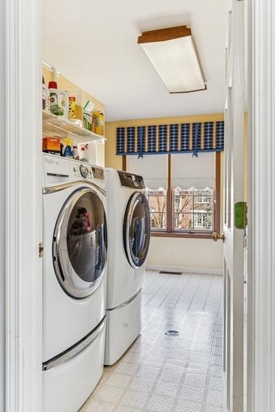washroom featuring light floors, attic access, separate washer and dryer, and laundry area