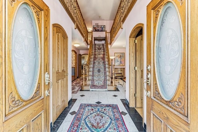 entrance foyer with arched walkways and stairs