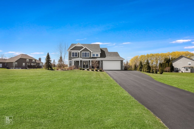 view of front of home with driveway, stone siding, a front yard, a garage, and a shingled roof