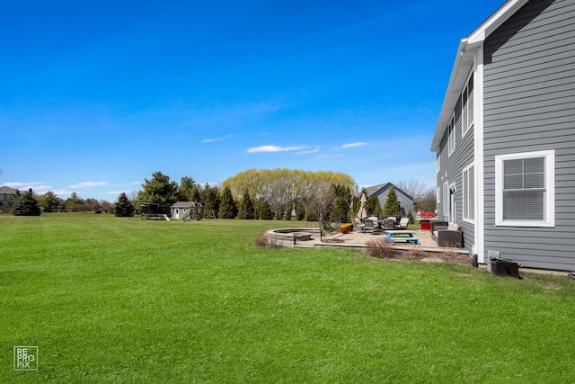 view of yard featuring a patio area and an outdoor fire pit