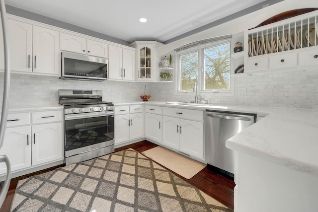 14232 Selva Ln, Orland Park, IL 60462 - kitchen with stainless steel appliances, open shelves, a sink, white cabinetry, and light countertops