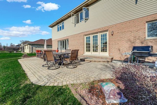 14232 Selva Ln, Orland Park, IL 60462 - rear view of house with a patio, brick siding, a lawn, and french doors