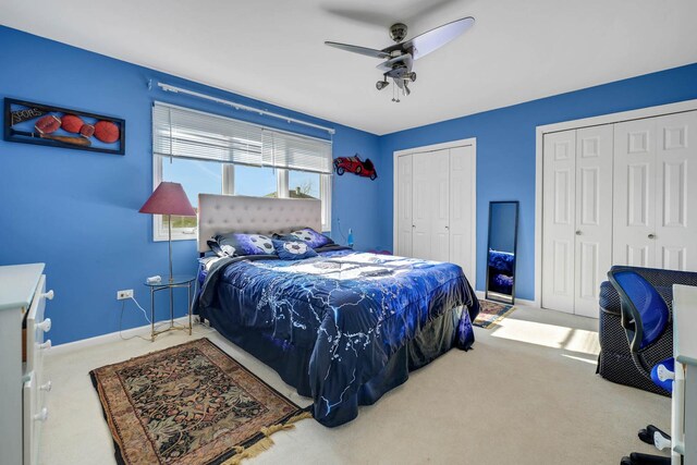 14232 Selva Ln, Orland Park, IL 60462 - carpeted bedroom featuring multiple closets, ceiling fan, and baseboards