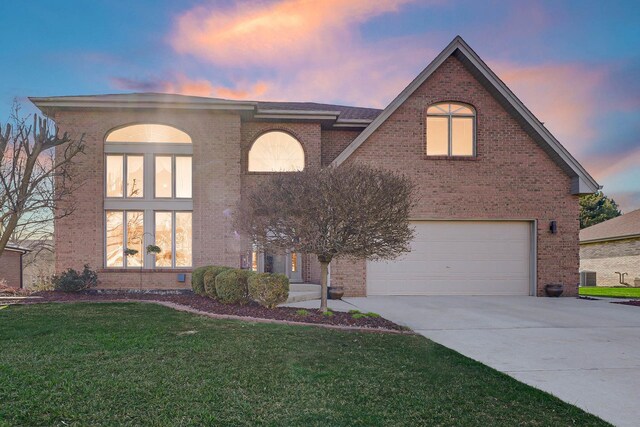 14232 Selva Ln, Orland Park, IL 60462 - view of front of home featuring a garage, concrete driveway, a front yard, and brick siding