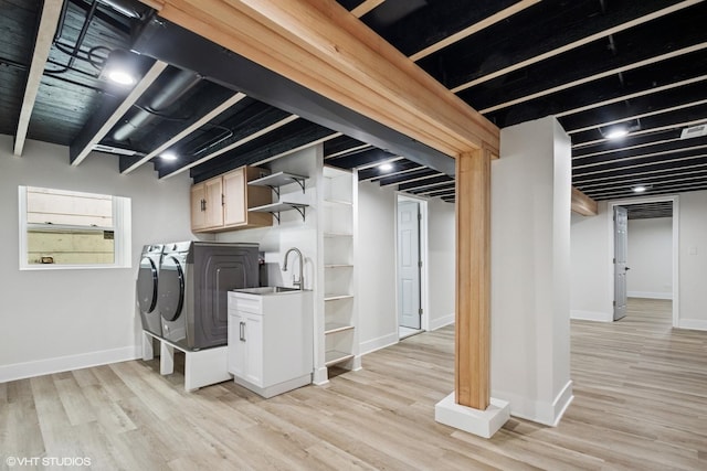 finished below grade area featuring baseboards, a glass covered fireplace, and wood finished floors