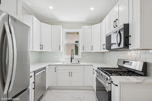 kitchen featuring marble finish floor, appliances with stainless steel finishes, and a wealth of natural light