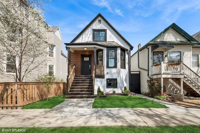 view of front of home featuring fence and stairway