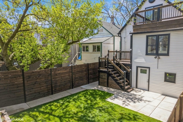 back of house featuring fence, a patio, stairway, and a balcony