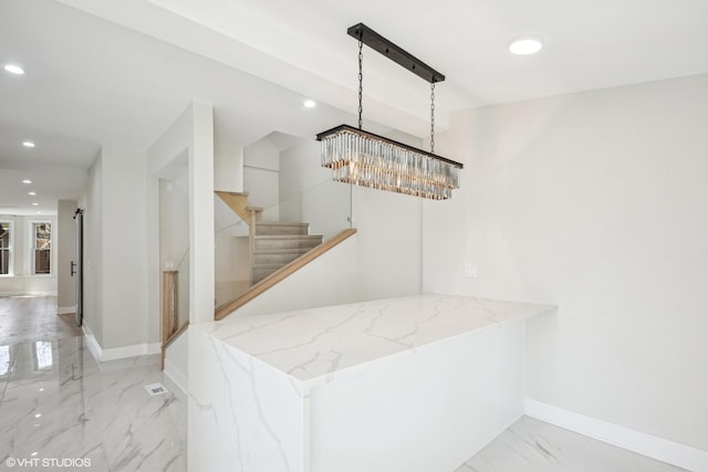 kitchen featuring marble finish floor, white cabinetry, light stone counters, a sink, and appliances with stainless steel finishes
