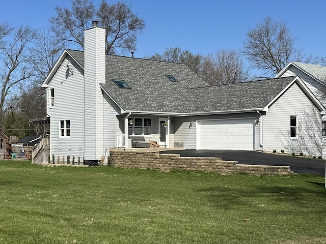 view of front of house featuring a front lawn, a chimney, covered porch, an attached garage, and a shingled roof