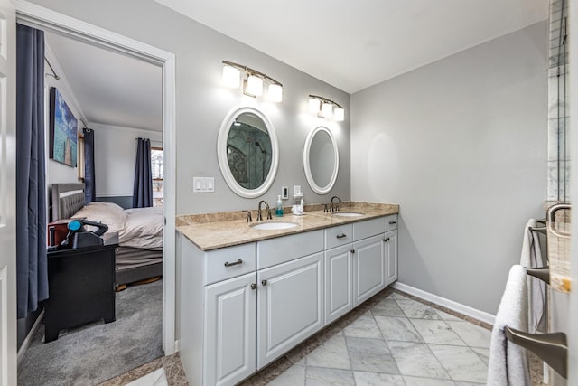 ensuite bathroom with ensuite bathroom, marble finish floor, a sink, and double vanity