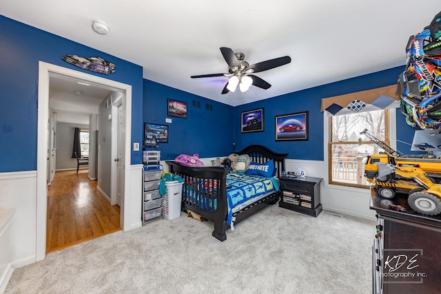 bedroom with carpet, ceiling fan, and multiple windows