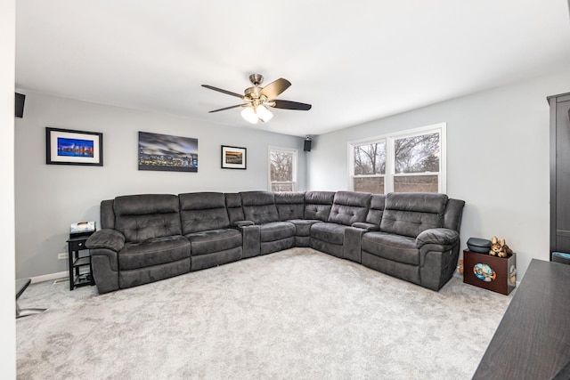 living room with ceiling fan and carpet