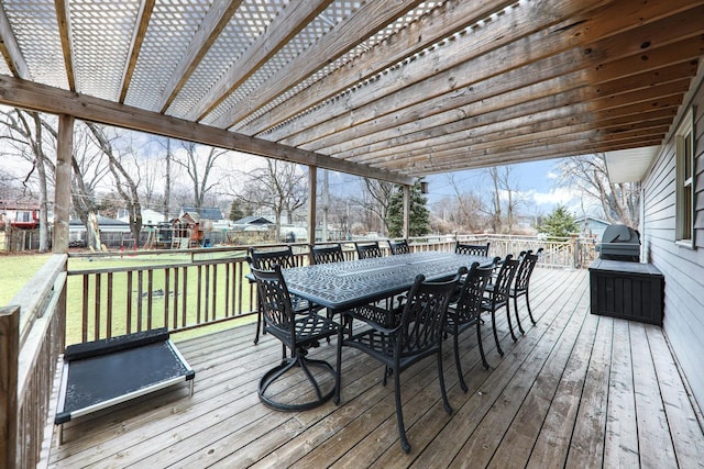 wooden deck featuring a yard, area for grilling, outdoor dining area, and fence