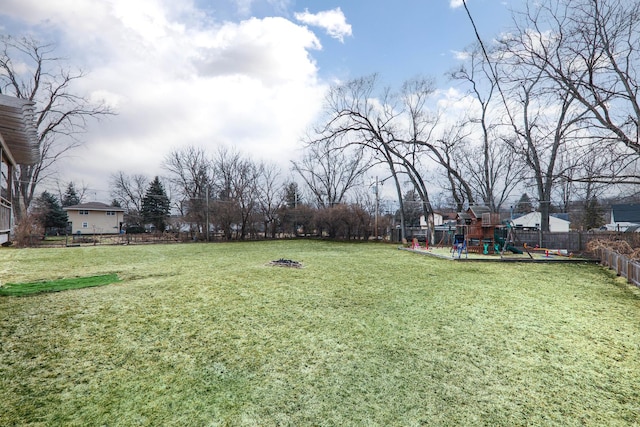 view of yard featuring a playground and fence