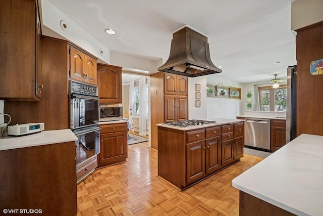 1704 Executive Ln, Glenview, IL 60026 - kitchen with stainless steel appliances, island exhaust hood, ceiling fan, light countertops, and recessed lighting