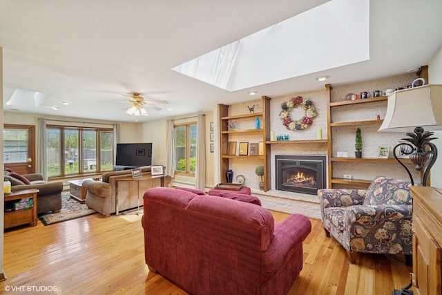 1704 Executive Ln, Glenview, IL 60026 - living area featuring a skylight, light wood-style floors, a large fireplace, recessed lighting, and ceiling fan