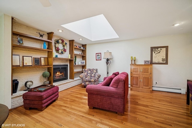1704 Executive Ln, Glenview, IL 60026 - living room featuring baseboard heating, a skylight, wood-type flooring, a glass covered fireplace, and recessed lighting