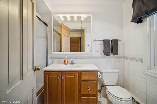 1704 Executive Ln, Glenview, IL 60026 - bathroom featuring tile walls, vanity, toilet, and a wainscoted wall