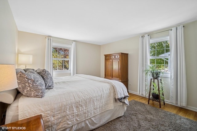 1704 Executive Ln, Glenview, IL 60026 - bedroom featuring multiple windows, wood finished floors, and baseboards