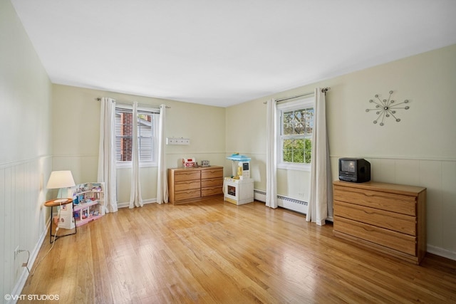 1704 Executive Ln, Glenview, IL 60026 - bedroom with a baseboard heating unit, wood finished floors, and wainscoting