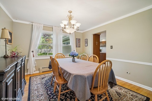 1704 Executive Ln, Glenview, IL 60026 - dining room featuring a chandelier, ornamental molding, baseboard heating, light wood-style flooring, and baseboards