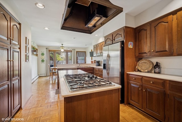 1704 Executive Ln, Glenview, IL 60026 - kitchen featuring appliances with stainless steel finishes, baseboard heating, light countertops, a peninsula, and a center island