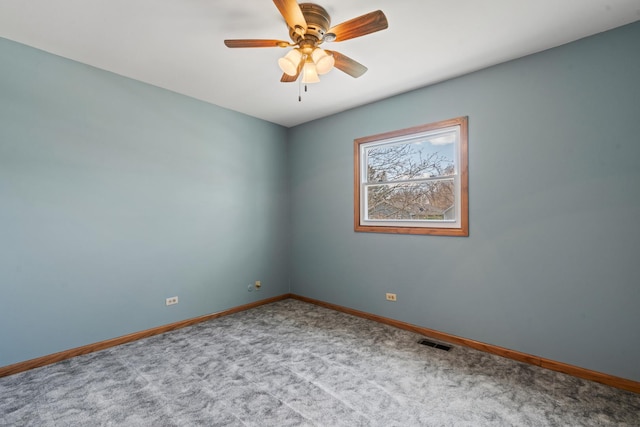 carpeted empty room featuring visible vents, baseboards, and ceiling fan