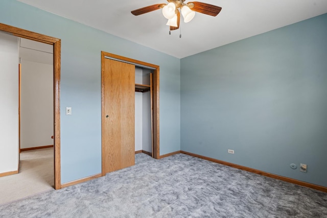 unfurnished bedroom featuring a closet, carpet flooring, baseboards, and ceiling fan