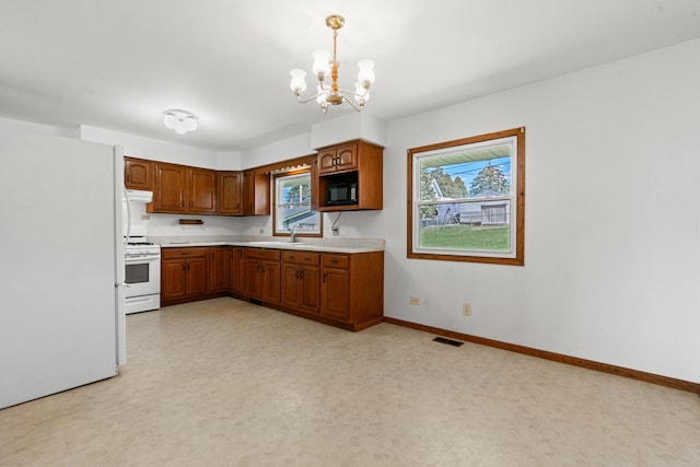 kitchen featuring light countertops, visible vents, white appliances, a chandelier, and brown cabinetry