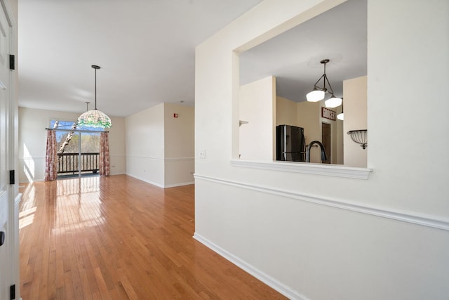 2543 Oneida Ln, Naperville, IL 60563 - hall featuring wood finished floors, a sink, and baseboards