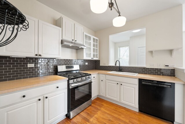 2543 Oneida Ln, Naperville, IL 60563 - kitchen with glass insert cabinets, stainless steel range with gas stovetop, black dishwasher, a sink, and under cabinet range hood