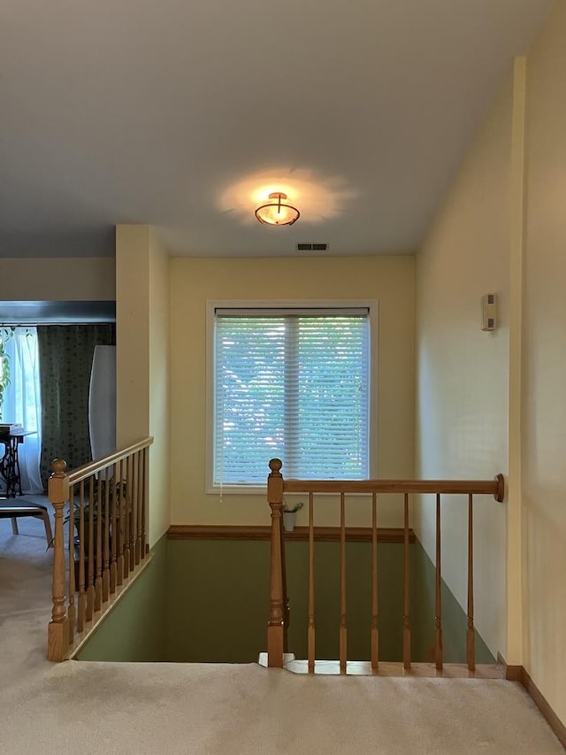 staircase featuring visible vents, baseboards, and carpet