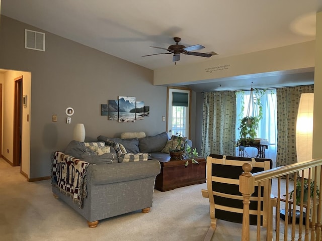 living area with visible vents, ceiling fan, light carpet, and baseboards