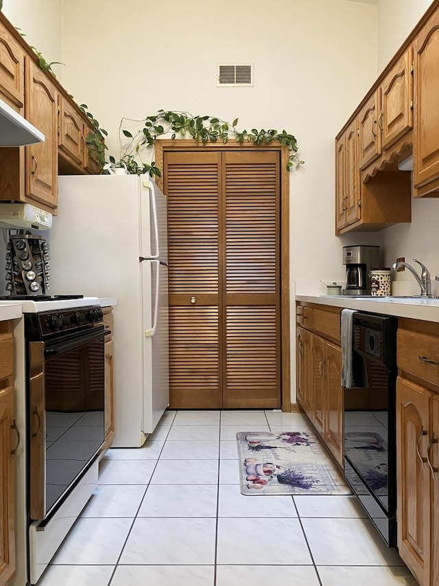 kitchen featuring visible vents, light tile patterned floors, dishwasher, light countertops, and gas stove