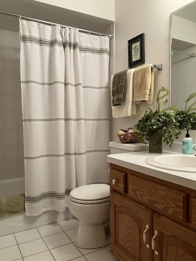 bathroom with tile patterned floors, shower / bath combo with shower curtain, vanity, and toilet