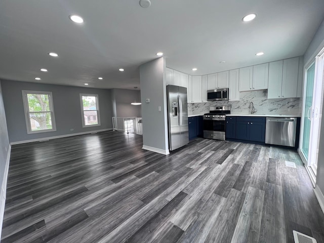 1170 Singleton Dr, Roselle, IL 60172 - kitchen with appliances with stainless steel finishes, light countertops, recessed lighting, backsplash, and dark wood-type flooring