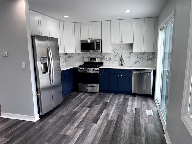 1170 Singleton Dr, Roselle, IL 60172 - kitchen featuring stainless steel appliances, blue cabinets, dark wood-type flooring, light countertops, and recessed lighting