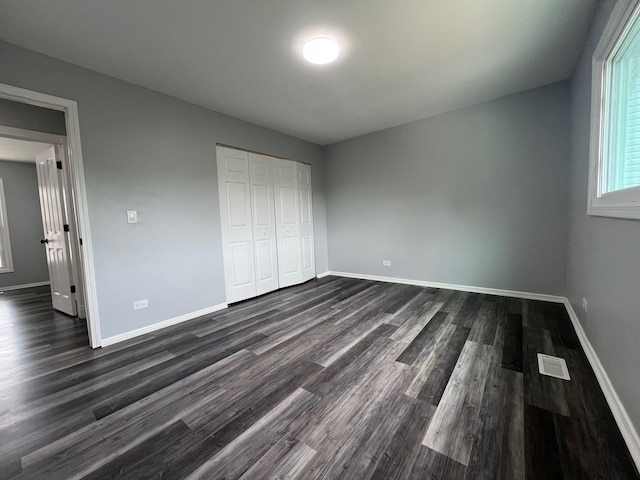 1170 Singleton Dr, Roselle, IL 60172 - unfurnished bedroom with dark wood finished floors, baseboards, and a closet