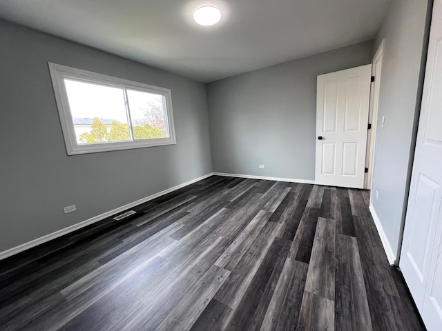 1170 Singleton Dr, Roselle, IL 60172 - unfurnished bedroom featuring dark wood finished floors and baseboards