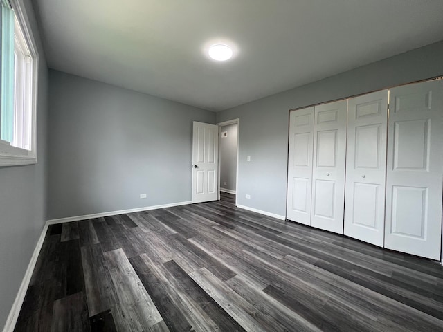 1170 Singleton Dr, Roselle, IL 60172 - unfurnished bedroom featuring dark wood finished floors, baseboards, and a closet