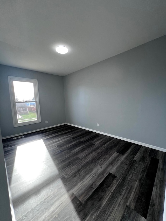 1170 Singleton Dr, Roselle, IL 60172 - empty room featuring dark wood-style floors and baseboards