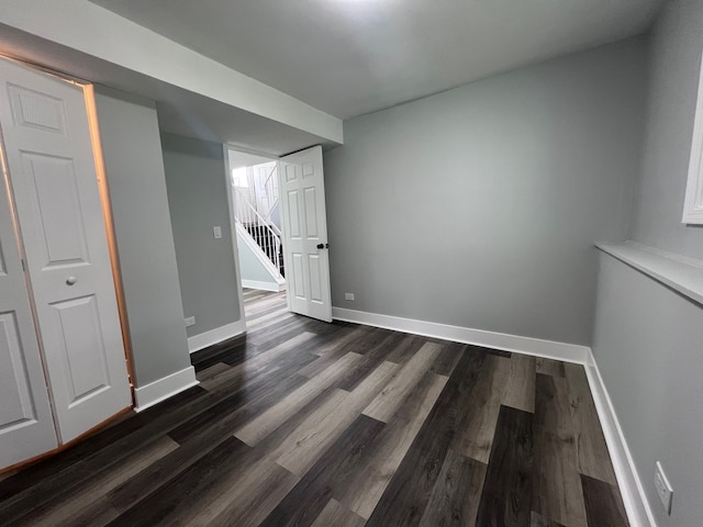 1170 Singleton Dr, Roselle, IL 60172 - spare room featuring dark wood finished floors, baseboards, and stairway