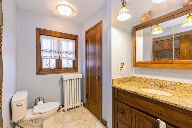 bathroom featuring marble finish floor, radiator heating unit, vanity, and toilet
