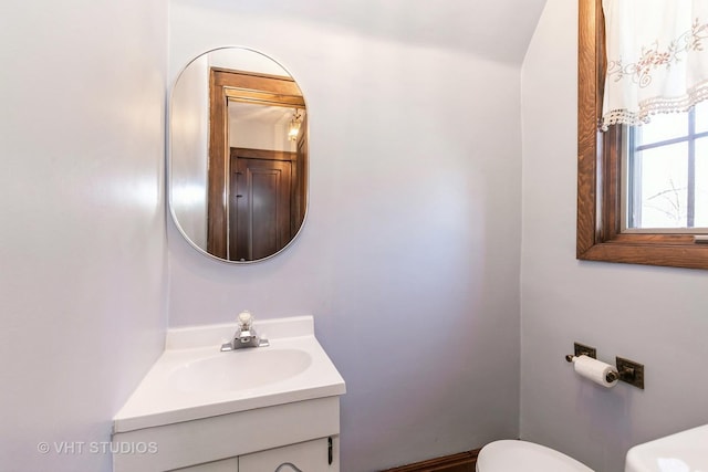 bathroom featuring toilet and vanity