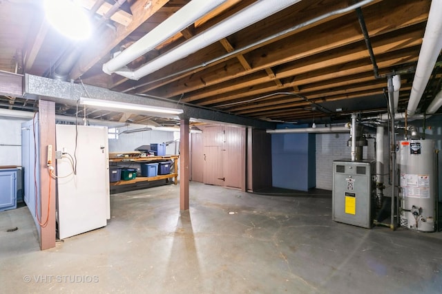 unfinished basement with water heater and freestanding refrigerator