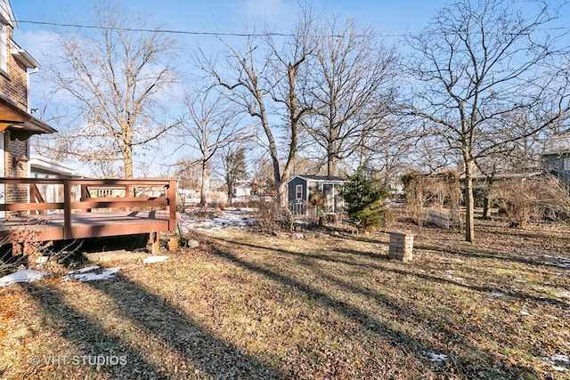 view of yard with an outbuilding and a wooden deck