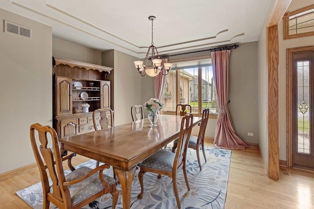 10440 Deer Chase Ave, Orland Park, IL 60467 - dining area featuring an inviting chandelier, visible vents, a raised ceiling, light wood finished floors, and baseboards