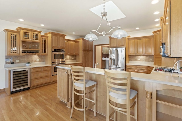 10440 Deer Chase Ave, Orland Park, IL 60467 - kitchen featuring a peninsula, appliances with stainless steel finishes, light countertops, wine cooler, and decorative backsplash