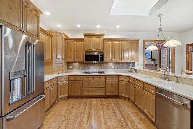10440 Deer Chase Ave, Orland Park, IL 60467 - kitchen featuring tasteful backsplash, a sink, light countertops, appliances with stainless steel finishes, and light wood-style flooring